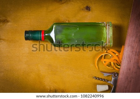 Bottle with absinthe on a wooden background