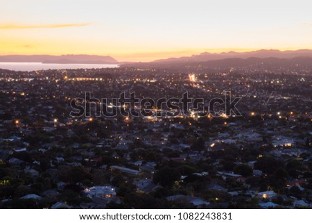 Beautiful View of a town in Auckland, New Zealand. Cloud sunset and town, View from Mt. Eden. Royalty-Free Stock Photo #1082243831