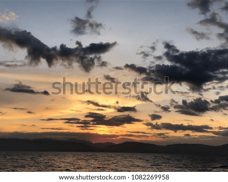 Tropical Sunset Beach Resort View with Mountains Background