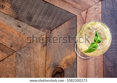 Florence, Tuscany / Italy. - May 3, 2018. A glass of white wine prosecco in a large glass with ice and mint leaves in a bar in Italy