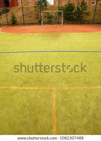 Empty gate. Outdoor football or handball playground plastic light green surface on ground