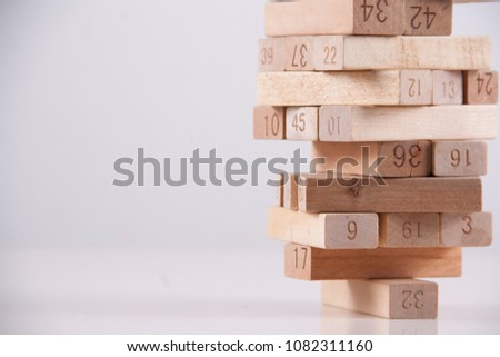 wooden block tower in white background with negative space.