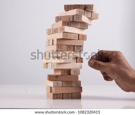 Wooden block concept. a men playing the wooden block tower. 
