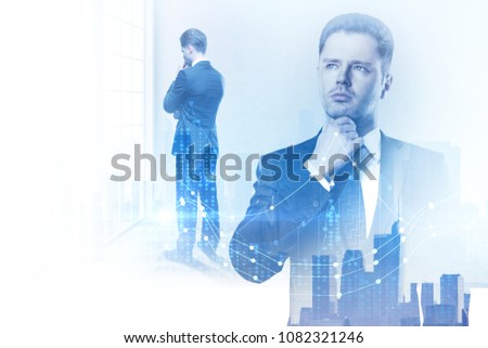 Thoughtful young businessman standing in blurry office interior with forex chart. Research, analysis and finance concept. Double exposure 