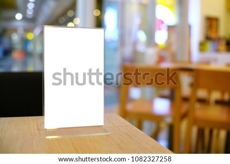 Menu frame standing on wood table in Bar restaurant cafe. space for text marketing promotion