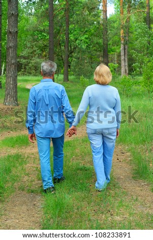 Older people are enjoying the fresh air surrounded by nature