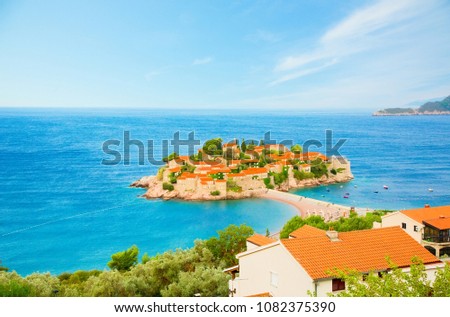 Beautiful panoramic Top view of the famous sight of Montenegro Sveti Stefan island on Budva Riviera. Luxury resort place in the Adriatic Sea in summer sunny day. Horizontal Wallpaper