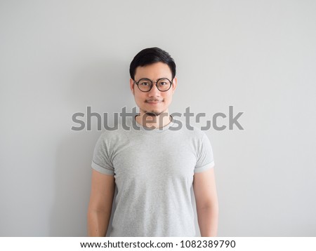 Normal face of ordinary Asian man with eyeglasses. Royalty-Free Stock Photo #1082389790