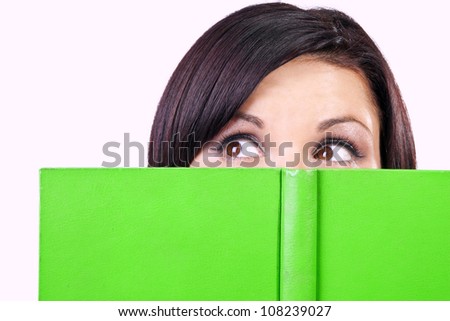 Closeup portrait of brunette with green book