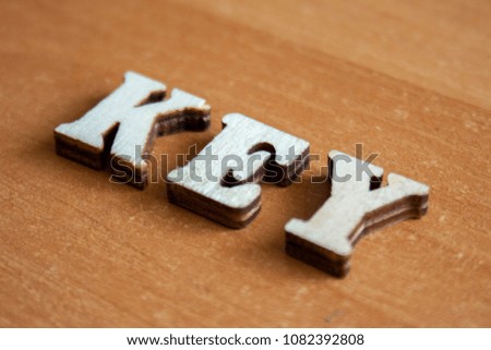 The word 'key' made of wooden letters. wood inscription on table