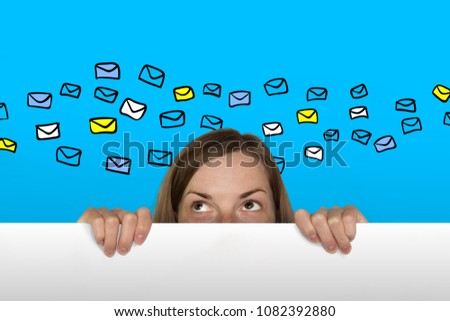 Girl Looks out from behind the White Sheet of Paper on the Blue Background. Added Icons in the Kind of Letters or Email. Dream Girl Concept