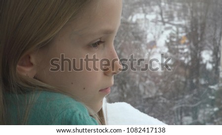 Sad Child Looking on Window, Unhappy Thoughtful Girl Face, Snowing Winter Day