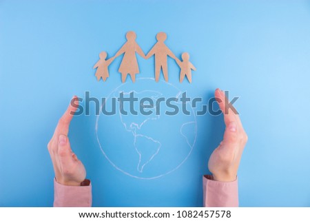 paper family on the earth planet. family and peace concept