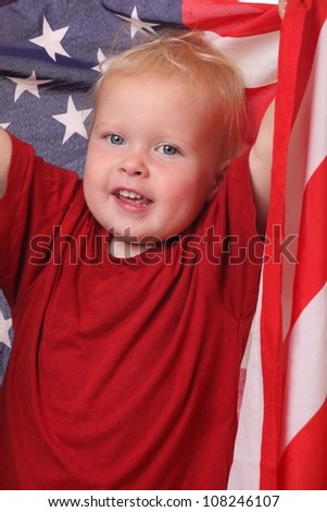 Portrait of a toddler with an american flag on white background