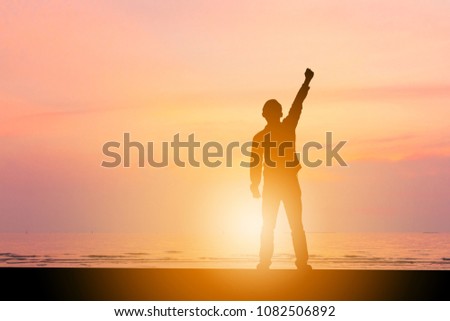 Silhouette of Man celebration success happiness on beach sunset evening sky background, Sport and active life concept, with clipping path