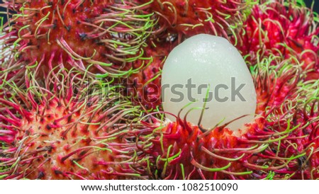 Close up of white pulp rambutan among red 