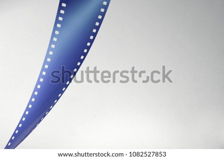 Blue film strip on gray background. Copy space for text.