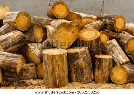 Folded logs near the fence after sawing