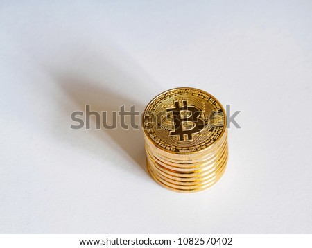 Close up image of piles of golden Bitcoin on white background with natural shadows, Financial concept, Chinese Currencies.