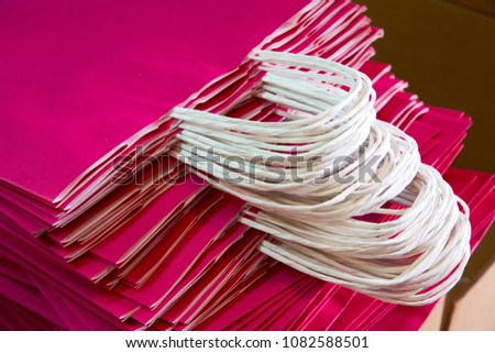 Paper bags atacked in a factory pink color bag