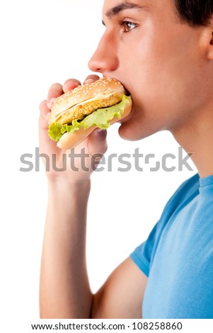 Young man eating hamburger
