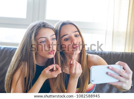 Teenager girls best friends makeup selfie camera in smartphone make-up