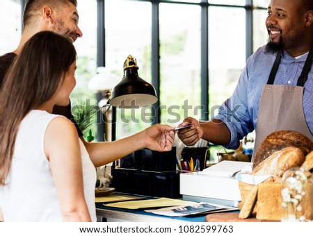 Customer paying for bakery products by credit card