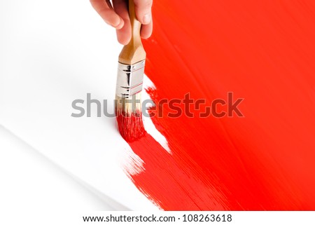 Painting with red ink and brush on white