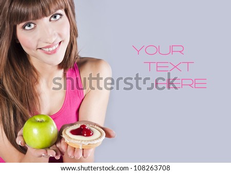 Girl with apple and cake in studio
