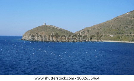 Photo from rocky seascape in entrance of port of Gavrio, Andros island, Cyclades, Greece   