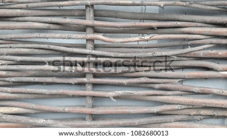 Wicker fence. Fence is woven from branches. Photo of a wicked fence