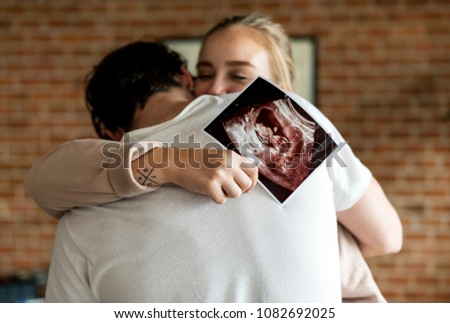 White couple with baby ultrasound photo Royalty-Free Stock Photo #1082692025