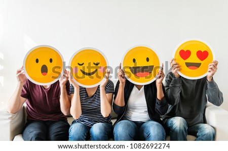 Diverse people holding emoticon Royalty-Free Stock Photo #1082692274
