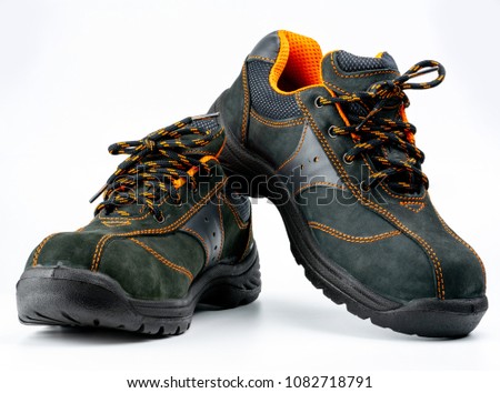 Pair of black safety leather shoes isolated on white background with copy space. Work shoes for men in factory or industry to protect foot from accident. Safety footwear. Oil and acid resistant shoes Royalty-Free Stock Photo #1082718791