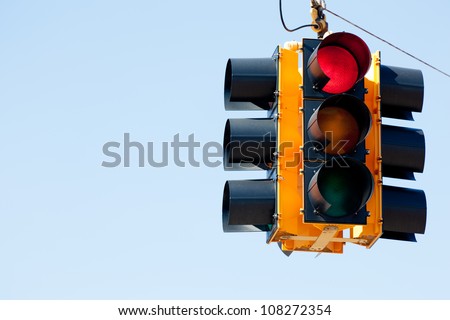 A red light traffic signal with blue sky copy space