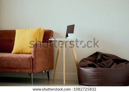 Livingroom interior with orang color shade fabric sofa and pillows with copy space