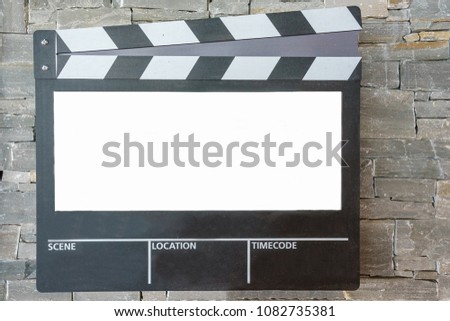 Blank mock up of clapper board,Movie clapper with copy space for your text message or content onstone wall background