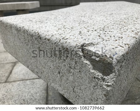 White granite stone seat in a small park in Hong Kong. It's depreciated and broken. Photo taken in May 2018. 