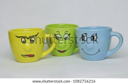 Three cups with faces