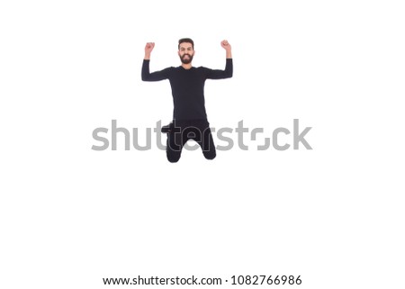 Happy  man wearing a casual outfit jumping up in the air and showing his hands muscles, isolated on white background