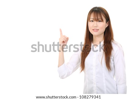 young asian businesswoman pointing up