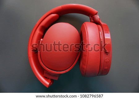 Bright red headphones for listening for music and audio/audible sounds.