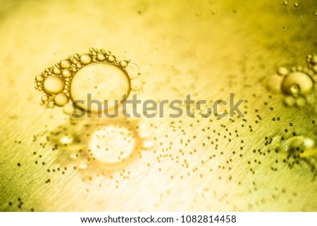 Oil drops and bubbles on a metal gear engine surface. Closeup photo.