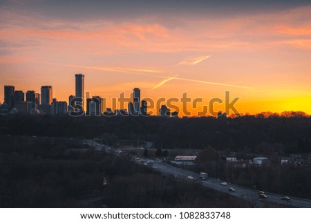 Bright colourful sunset over downtown Toronto office buildings and condominiums.
