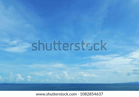 Sea and blue sky with white clouds.