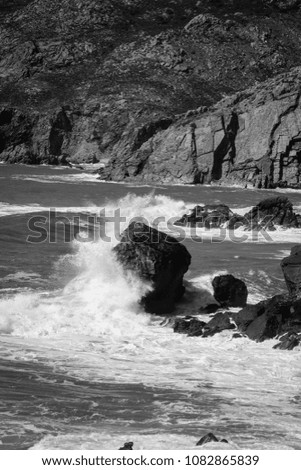Waves hit a big rock near from the coastline. Seascape in the Portugal