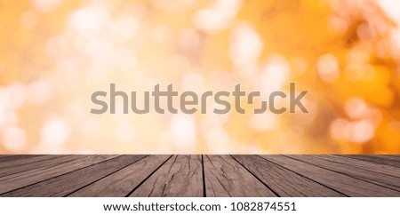 old vintage brown wood tabletop with blurred nature bokeh light orange color toned background for advertising products on display picture