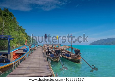 view of many long-tail boats floating in the port with blue sky background, Chong Khao Khad, Surin island, Phang Nga, southern Thailand