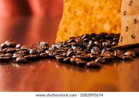 background.coffee beans on wooden table. Background of ground coffee texture. Coffee beans are scattered on the table.Packaging for coffee