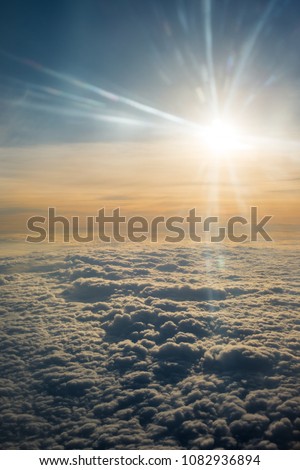 A Close-up of Clouds and Sun Photo Taken on the Airplane